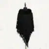Poncho noir à capuche fourrée et franges, boutons décoratifs.