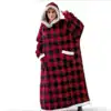 Poncho plaid rouge et noir à capuche avec poches, doublure en fausse fourrure blanche.