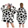Poncho plaid enfant vache, motif tache noir et blanc, capuche avec oreilles et museau.