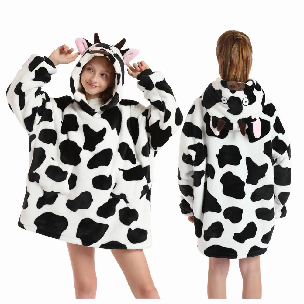 Poncho plaid enfant vache, motif tache noir et blanc, capuche avec oreilles et museau.