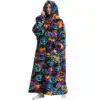 Poncho polaire femme motif citrouilles Halloween, capuche, poches, confort.